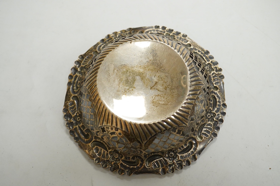 Small silver including two Edwardian caddy spoons, one German with import marks, a George V vesta case, a late Victorian pierced bonbon dish and a modern mounted steel cigar cutter.